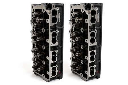 Two engine cylinder heads on a white background