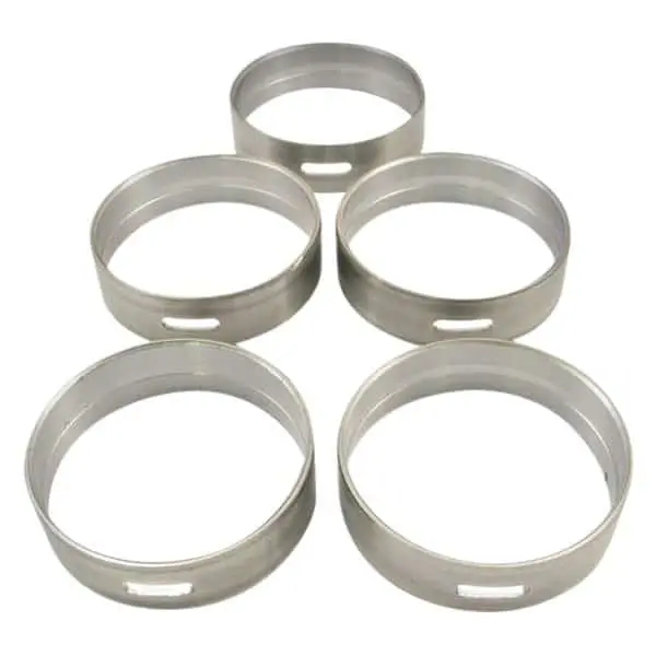 Five metal pastry rings arranged in formation.