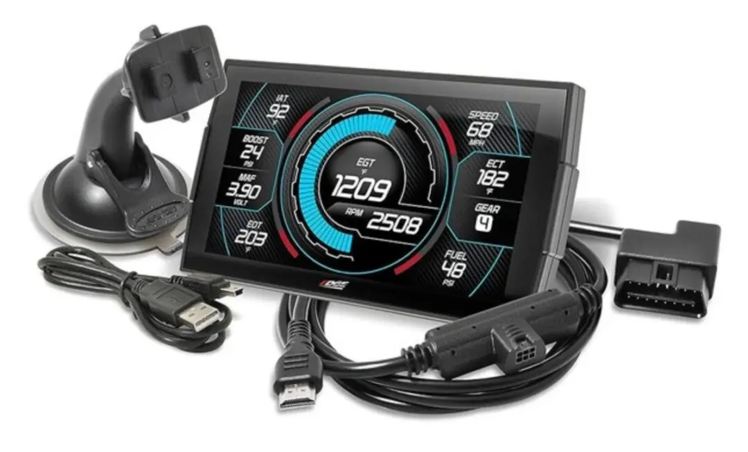 A digital gauge display with cables and connectors.