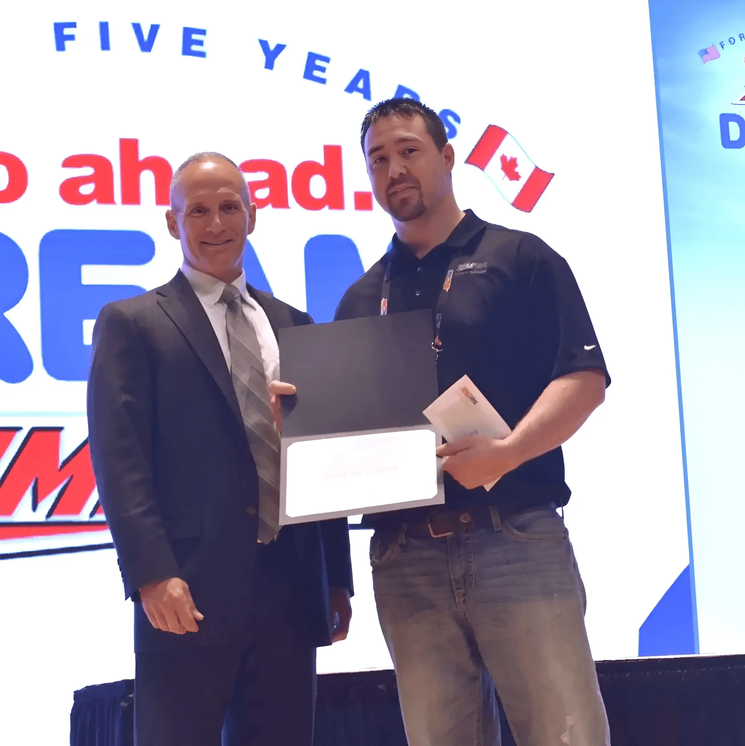 Two men at an award ceremony.