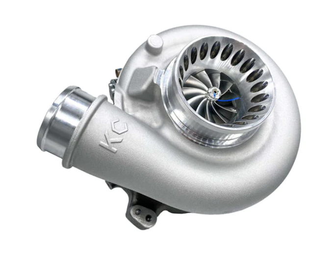 A shiny silver turbocharger with visible turbine blades.