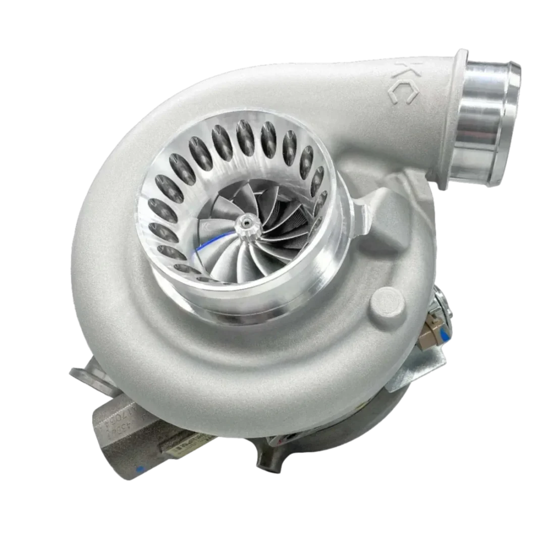 A close-up of a silver turbocharger with visible turbine blades.